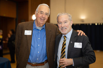 Chancellor Rich Lyons (right) greets alum and longtime supporter of UC Berkeley undergraduates Bob Haas.