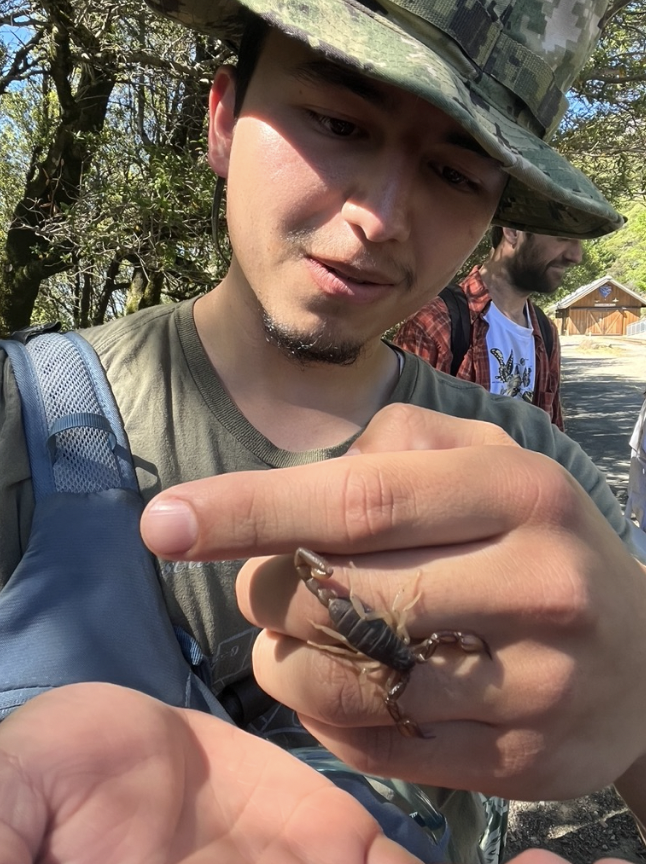 Emilio Salvador Chavez holding a reptile